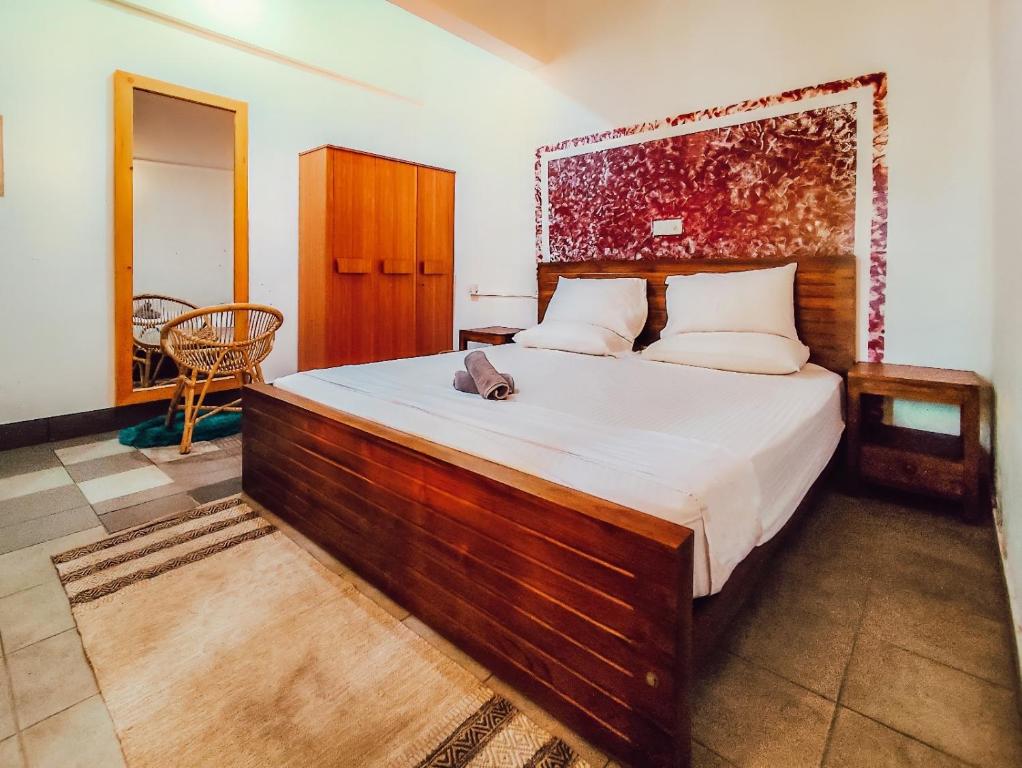 Ένα ή περισσότερα κρεβάτια σε δωμάτιο στο Hummus Hostel Hikkaduwa
