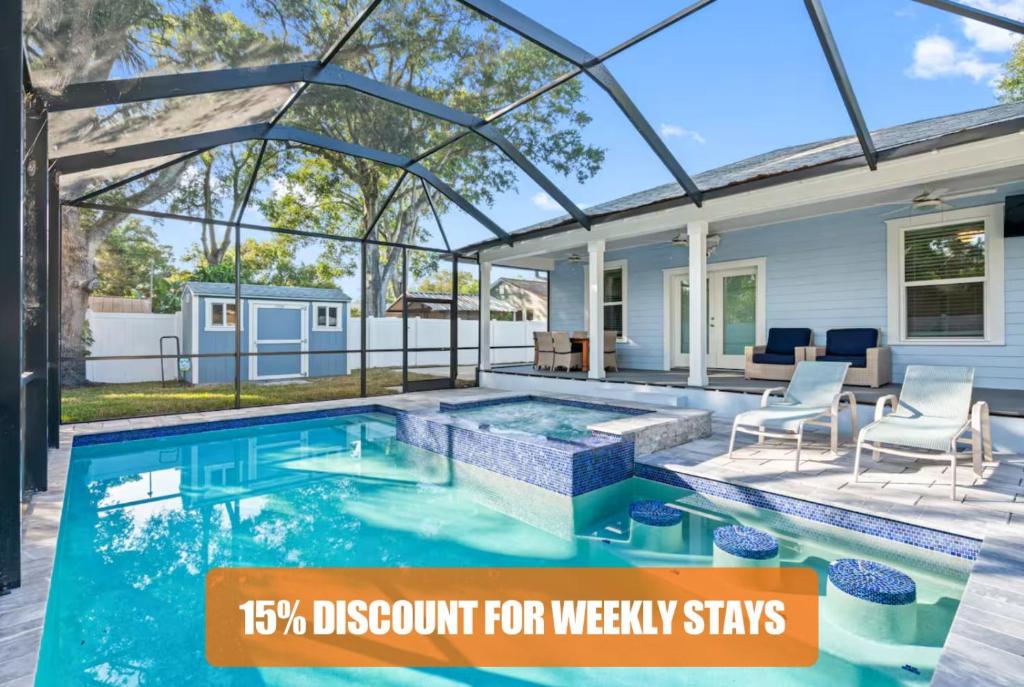a swimming pool in a house with discount for weekly stays at Luxury Stay Heated Pool and Hot Tub Fenced Yard in Tampa