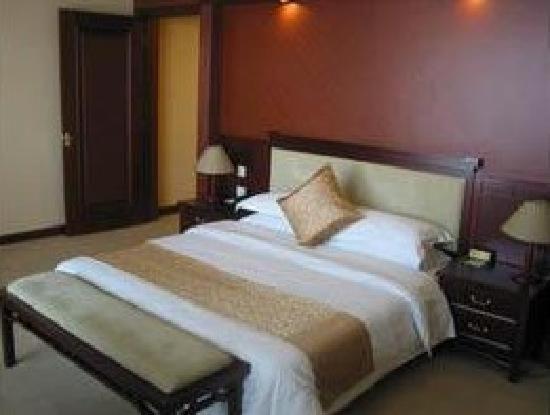 Postel nebo postele na pokoji v ubytování Xinlu Hotel