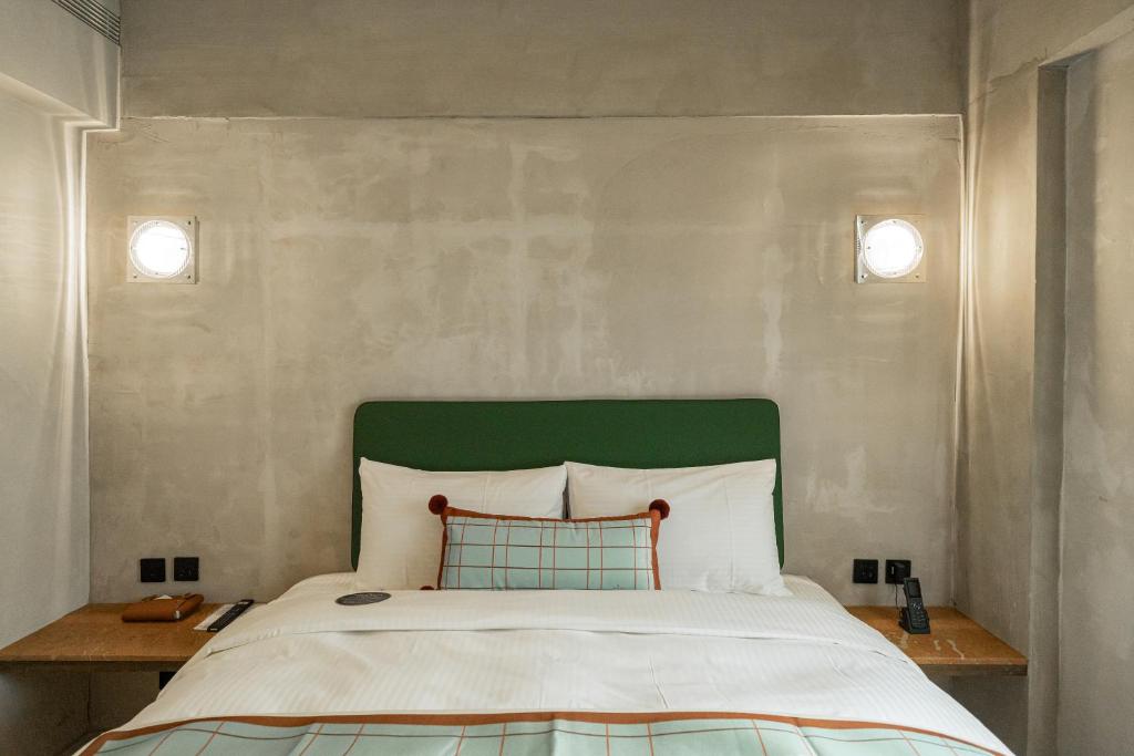 En eller flere senge i et værelse på PAPO'A Labs