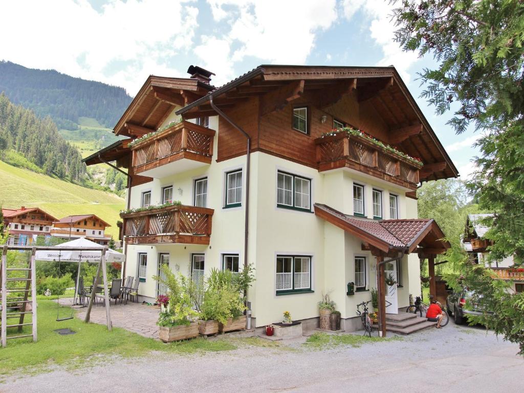 a large house with wooden balconies on top of it at Apartment in Grossarl near Ski Slopes in Grossarl