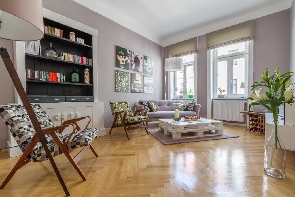 a living room with a couch and a table at Apartment Vienna Your home abroad in Vienna