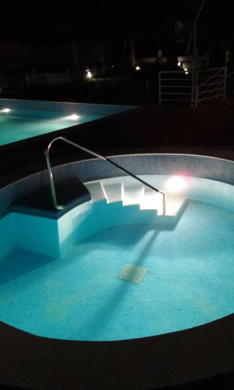 a swimming pool at night with a hose in it at Casa do Pateo in Casa Branca