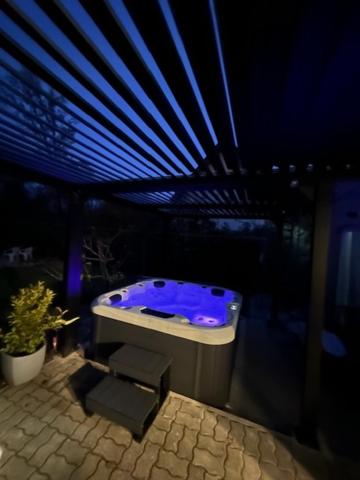 a bathroom with a blue tub in a building at Verandás Vendégház in Balatonkenese