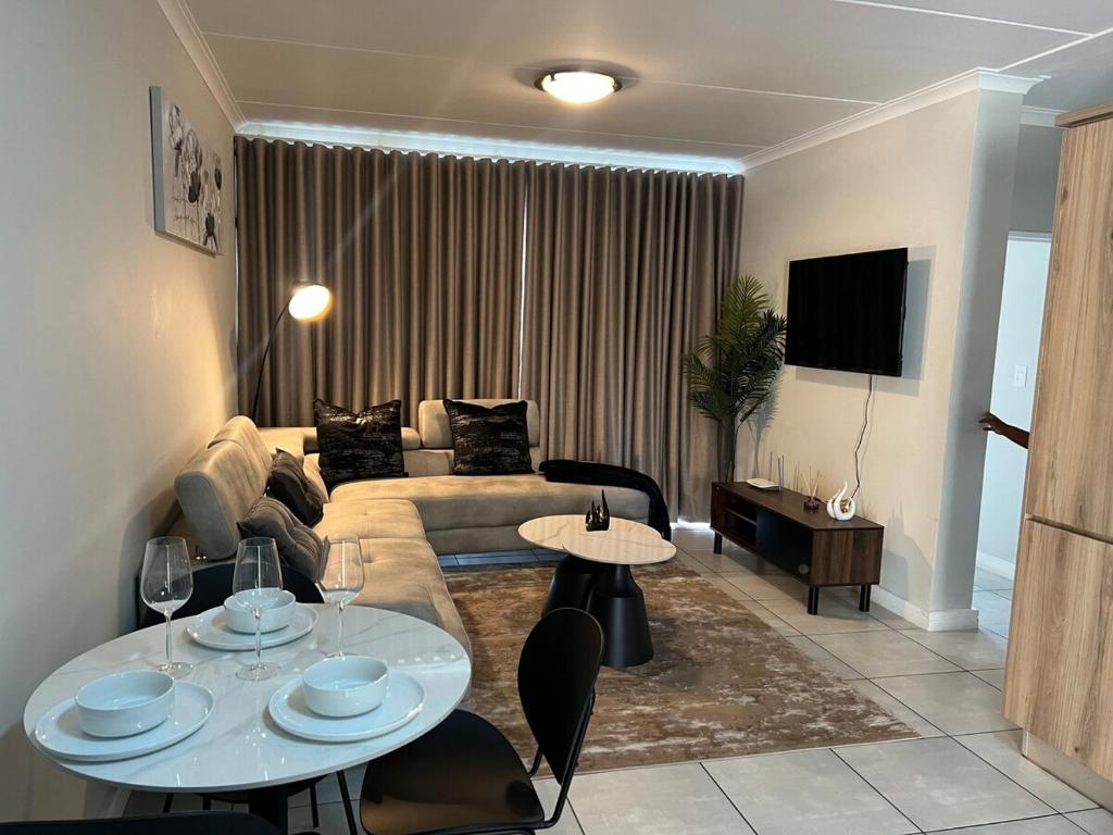a living room with a couch and a table at 2 Bed at the Blyde in Pretoria