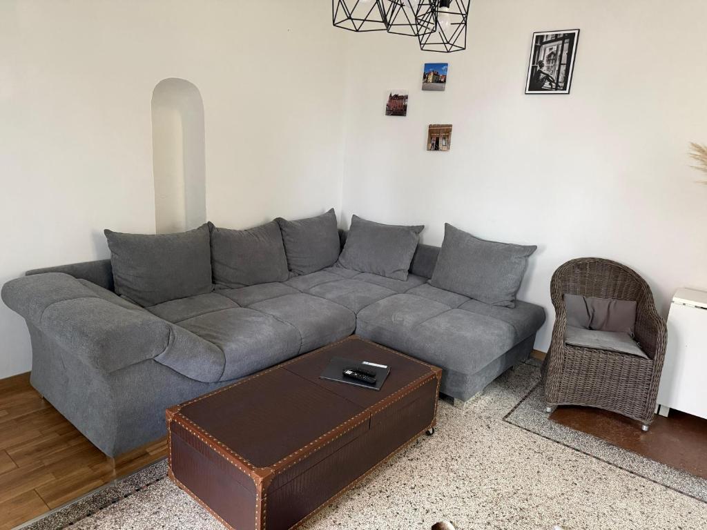 a living room with a gray couch and a table at Villa Rathenow in Rathenow