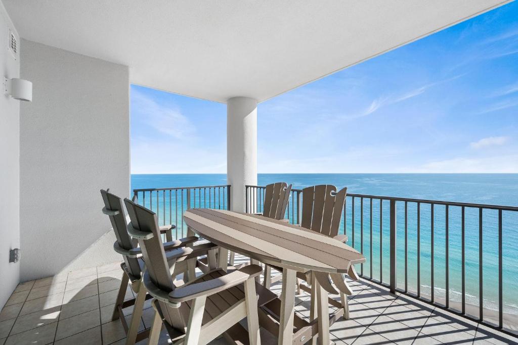 a table and chairs on a balcony with the ocean at The Oasis at Orange Beach 2208 (Phoenix West II) in Orange Beach