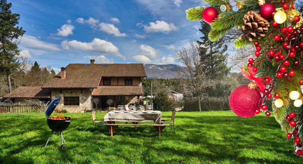 a table and a grill in front of a house at The Basque Experience by Fidalsa in Ochandiano