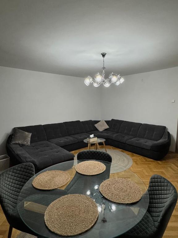 a living room with a couch and a table and chairs at Central Apartment KM 0 in Craiova
