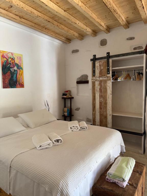 a bedroom with a bed with towels on it at Venereum Apartments in Faros