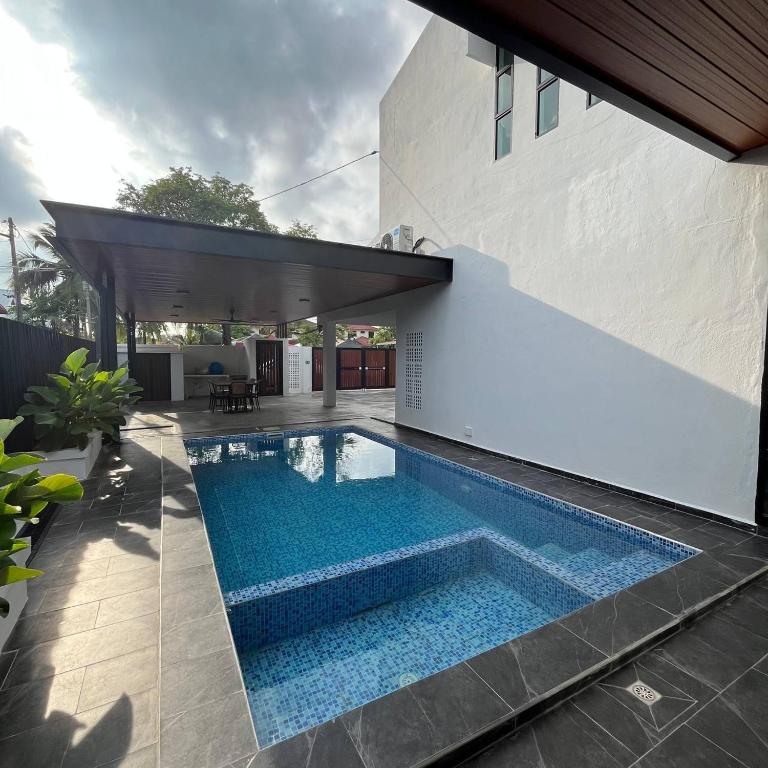 a swimming pool in the middle of a house at CasaD'Tamarind Homestay with Private Pool in Alor Setar