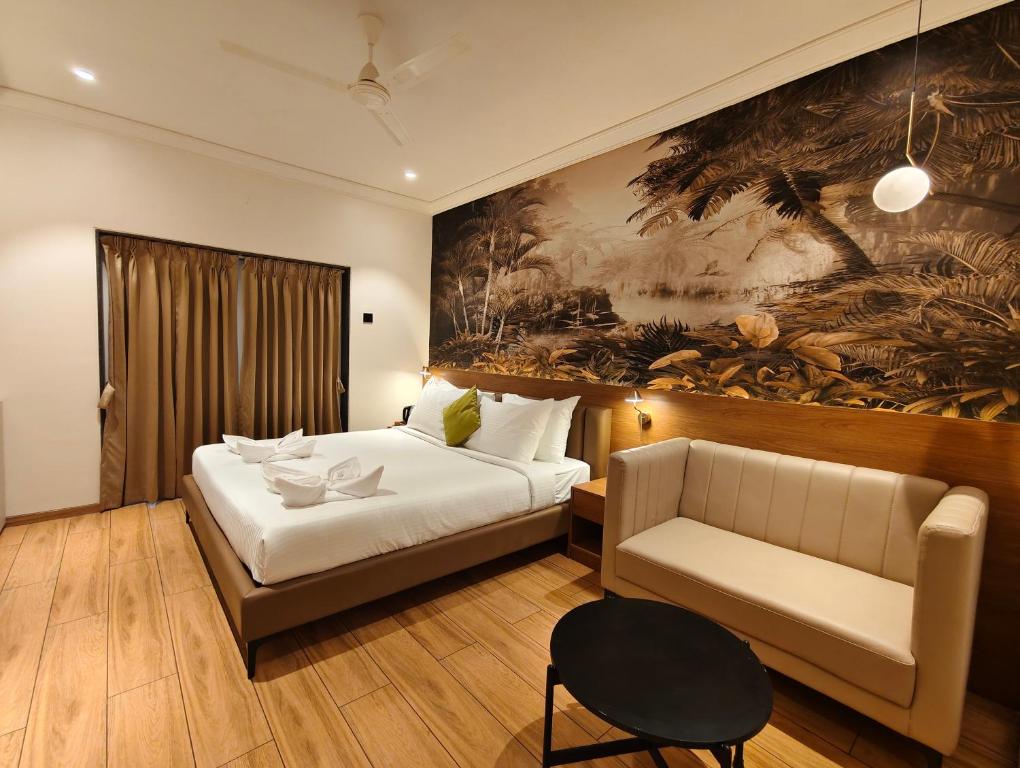 a hotel room with a bed and a couch at Regenta Z Mahabaleshwar in Mahabaleshwar