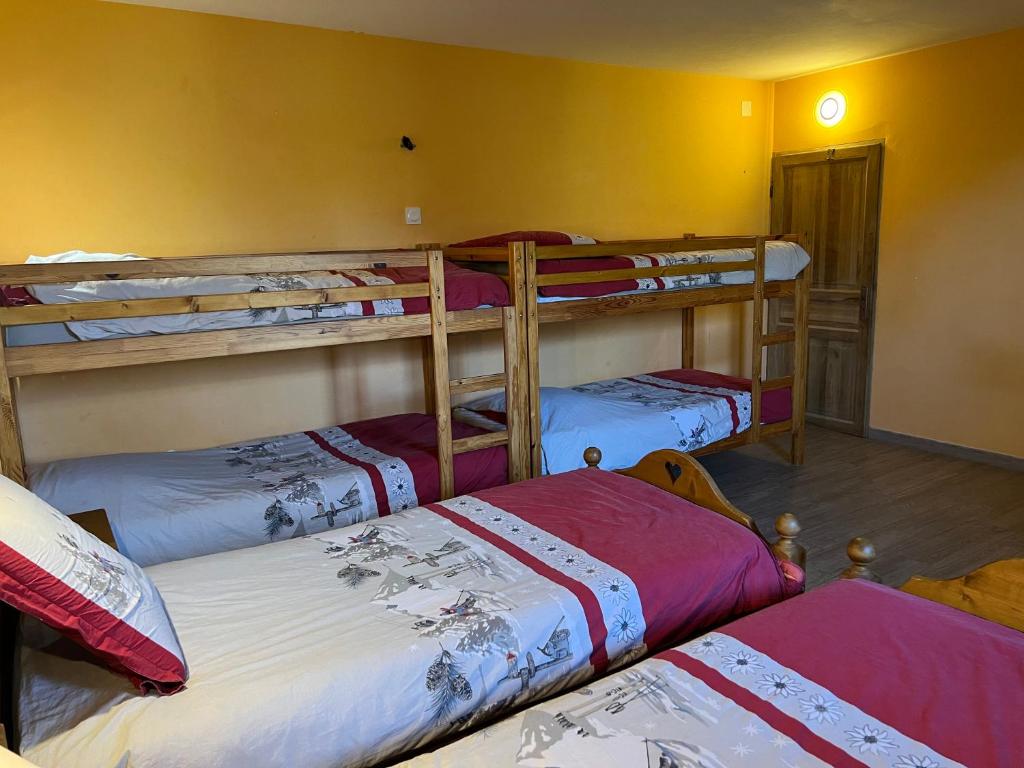 a room with three bunk beds in a room at La Maison des Coeurs in Lugrin