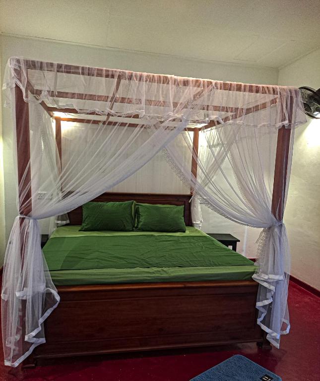 a bedroom with a bed with a canopy at The Glown Weligama in Weligama
