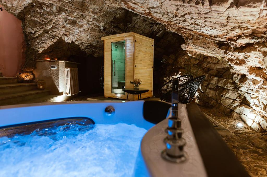 a bath room with a tub in a cave at Casa di Lucy Spello - Cave Wellness & Panoramic View in Spello