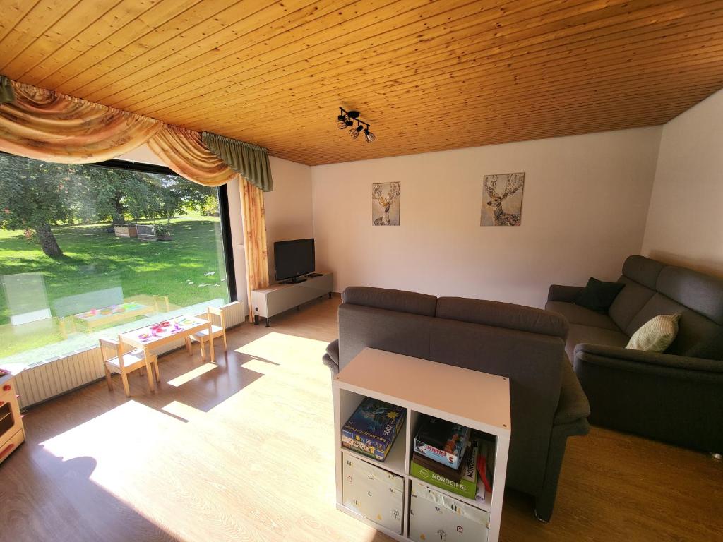 a living room with a couch and a table at Familiennest-Eifel in Blankenheim