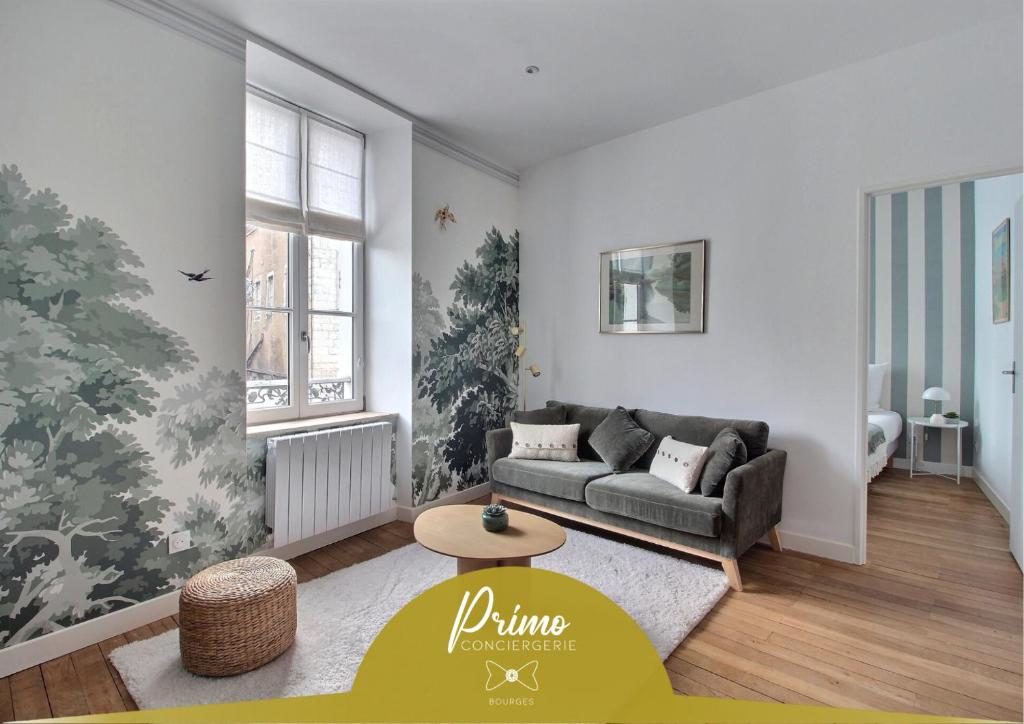 a living room with a couch and a table at Le Refuge des Bourbons by PRIMO C0NCIERGERIE in Bourges