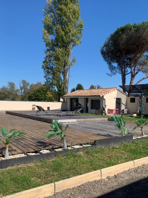 una casa con una mesa de picnic en una terraza en Apartment - Garden Studio - en extérieur de Bordeaux, en Tresses