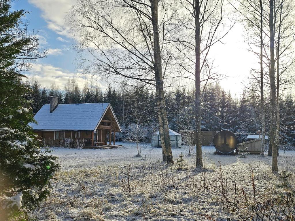 eine Hütte auf einem Feld mit Schnee auf dem Boden in der Unterkunft 2-bedroom, fenced yard, sauna, 10 min to Pärnu in Pärnu