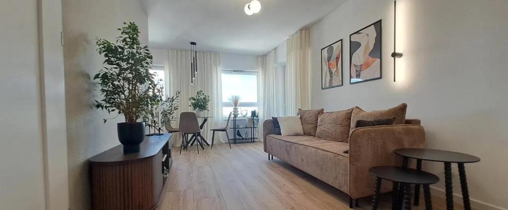 a living room with a couch and a table at Studio Magnolia Suite in Poznań