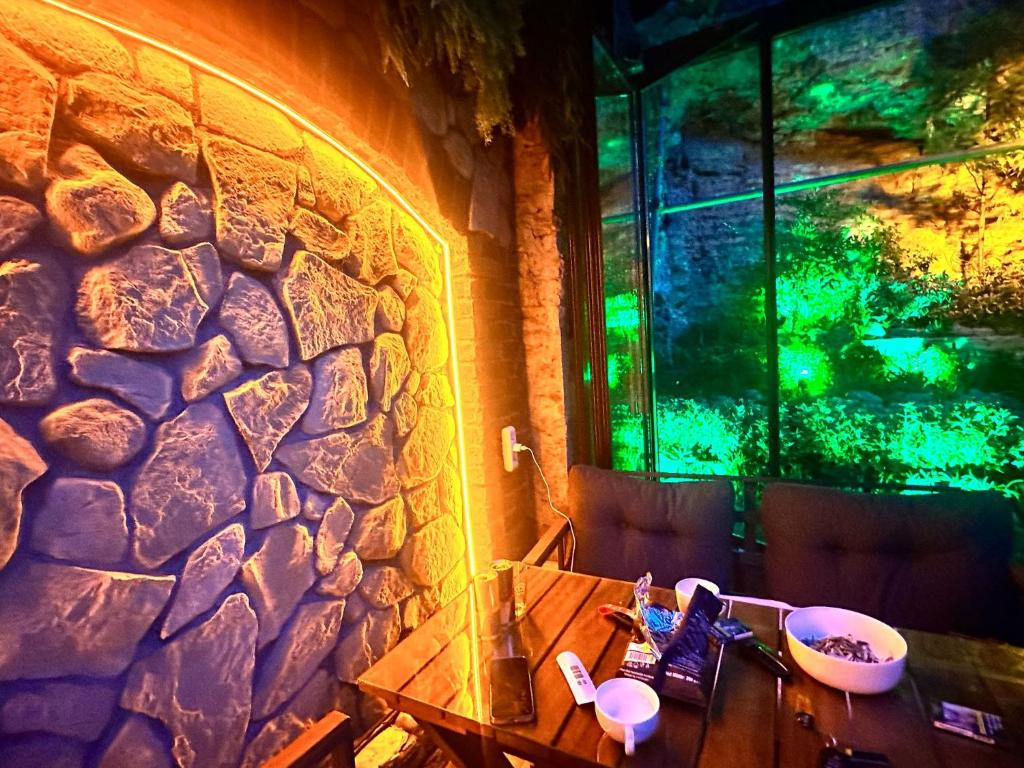 a room with a stone wall with a table and a window at Hotel SPHENDON in Istanbul