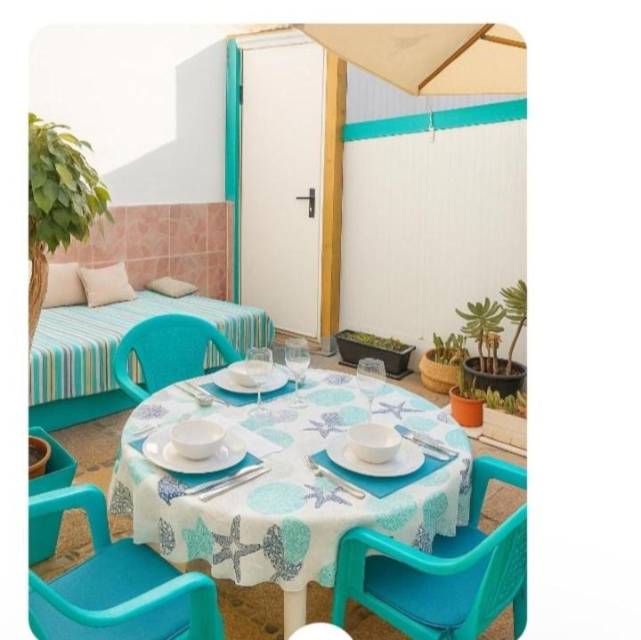 a room with a table and chairs and a couch at Maspalomas Pasito in Pasito Blanco