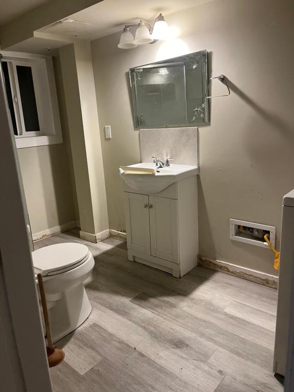 a bathroom with a toilet and a sink at Tillicum center 6 bedroom house in Oak Bay
