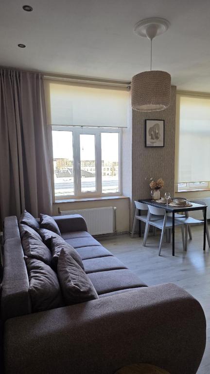 a living room with a couch and a table at Center apartment Great Amber in Liepāja