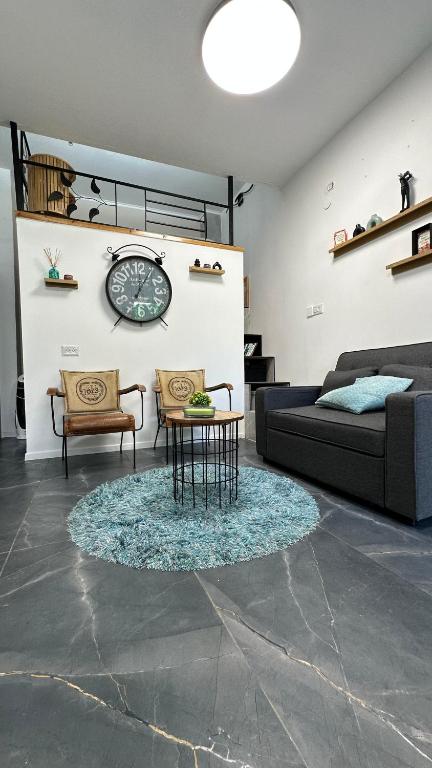 a living room with a couch and a table at Sweet in Nahariyya