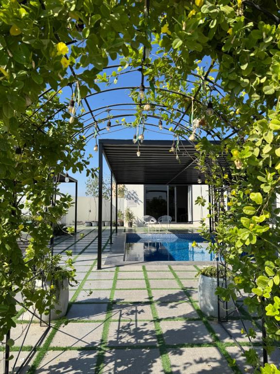 an external view of a house with a pool at Lamour Villa in Şallān