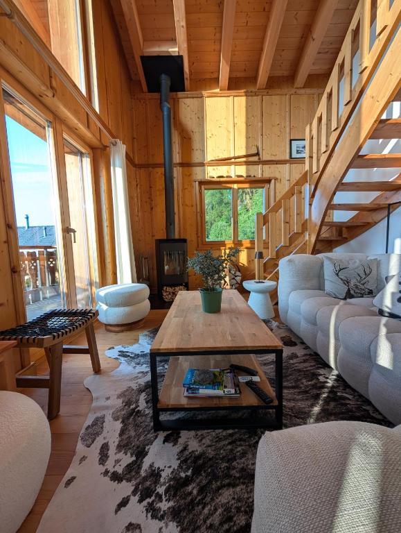 a living room with a couch and a coffee table at Chalet Asphodel in Nendaz