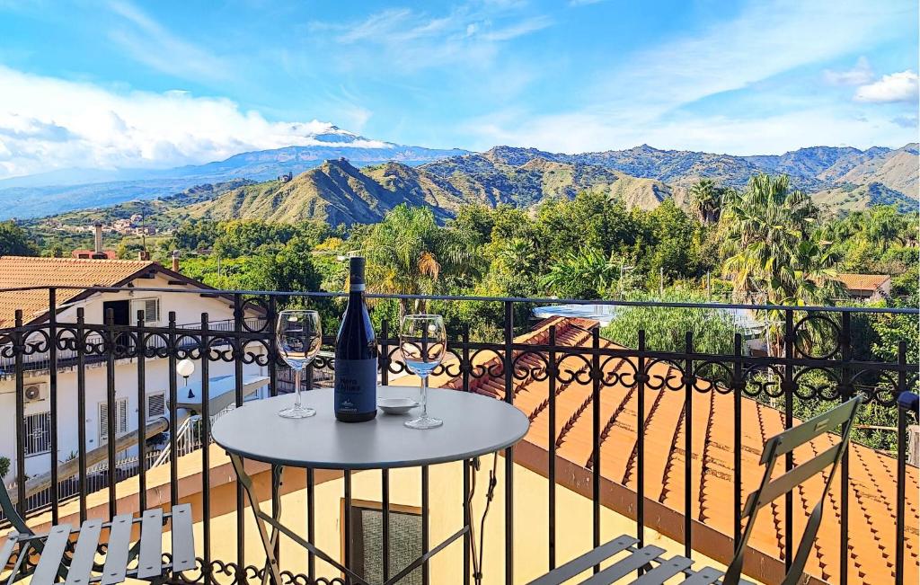 eine Flasche Wein auf einem Tisch auf einem Balkon in der Unterkunft Amazing Apartment In Trappitello in Trappitello
