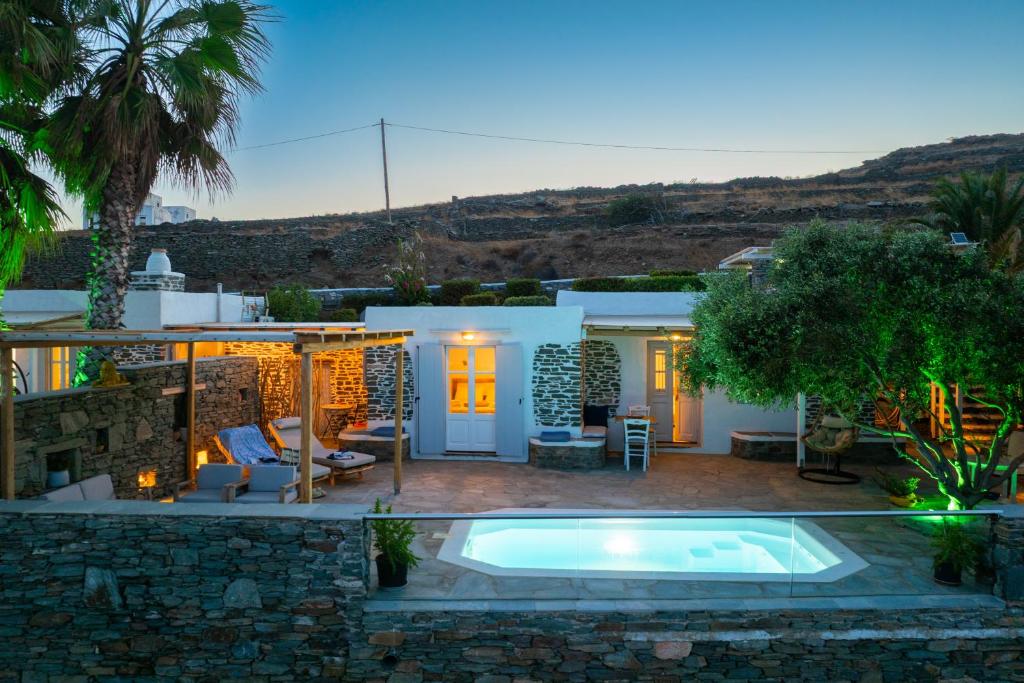 a backyard with a swimming pool and a house at Efthymia apartments in Faros