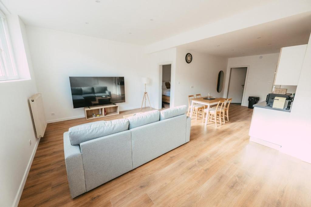 a living room with a couch and a table at Appartement lumineux et calme sur la Route des vins in Guebwiller