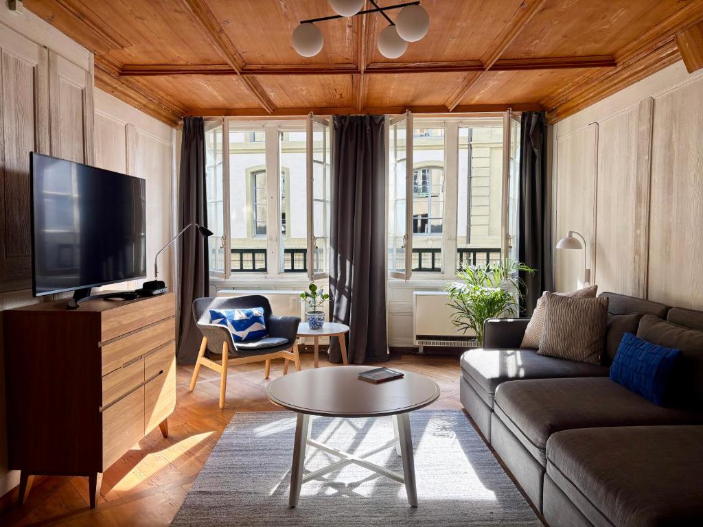 a living room with a couch and a tv at Steps To Bern's Best Historic Sites! in Bern