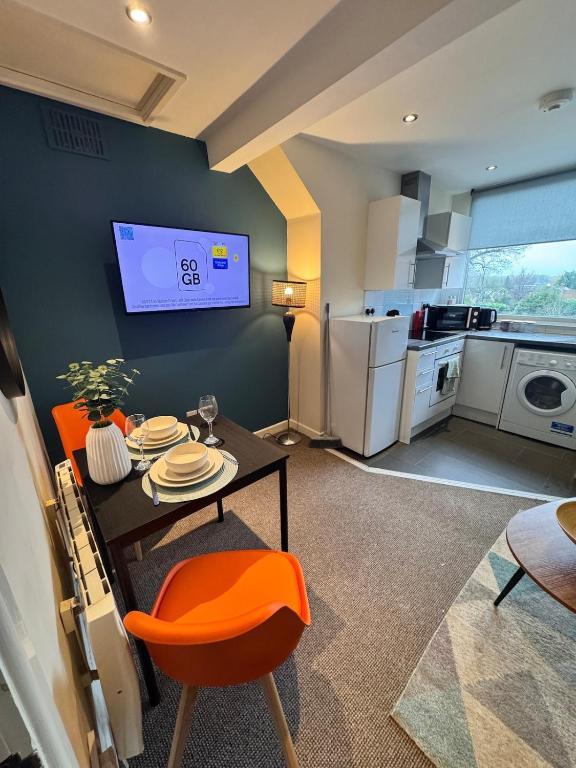 a living room with a table and a kitchen at #81 Stylish Top Floor - for 2 - 10 mins to Brueton Park - " Perfect for Business Traveler and Couple - Free Parking" in Shirley