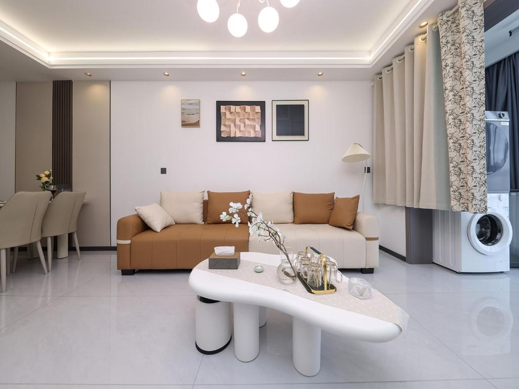 a living room with a couch and a table at Annie Apartment 2105 in Kunming