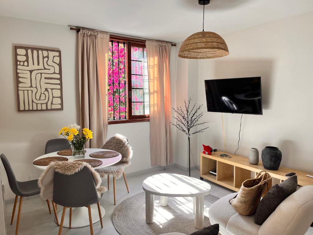 a living room with a couch and a table at Buganvilla Garden Puerto de la Cruz in Puerto de la Cruz