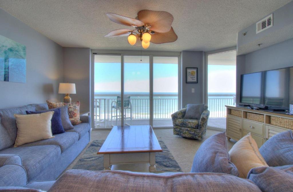 a living room with a couch and a television at Crescent Shores South - 510 in Myrtle Beach