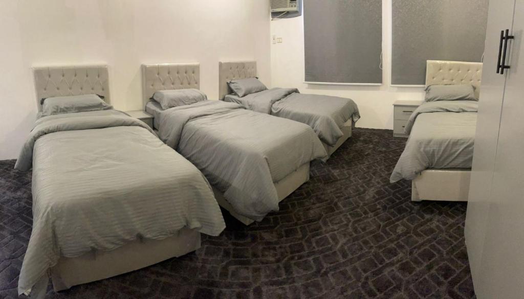 a room with three beds in a room at شقة الخالدية 1 in Al Madinah