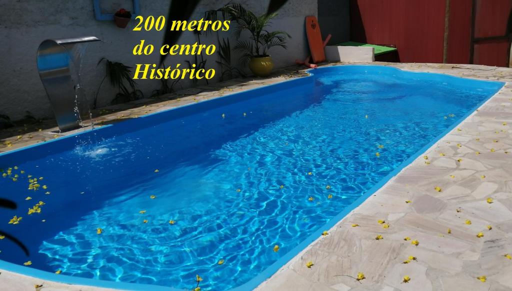 a swimming pool with blue water in a house at Pousada Estrada Real in Paraty