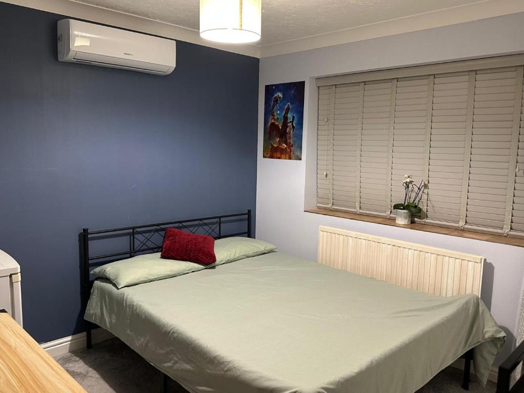 a bedroom with a bed with a red pillow on it at Bnb in Abbeymead