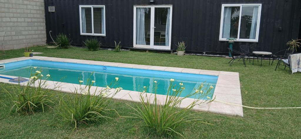a small swimming pool in a yard next to a house at El Contenedor Premium in San Francisco
