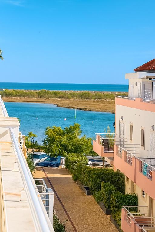 a view of the ocean from the balcony of a building at Ria Seahouse Cabanas de Tavira in Tavira