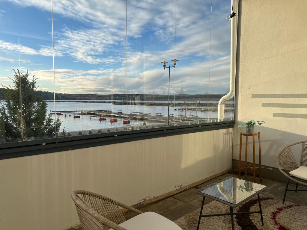 ein Balkon mit großem Fenster mit Blick auf den Hafen in der Unterkunft Kaksio järvinäkymällä ja saunalla Lahden Satamasta in Lahti
