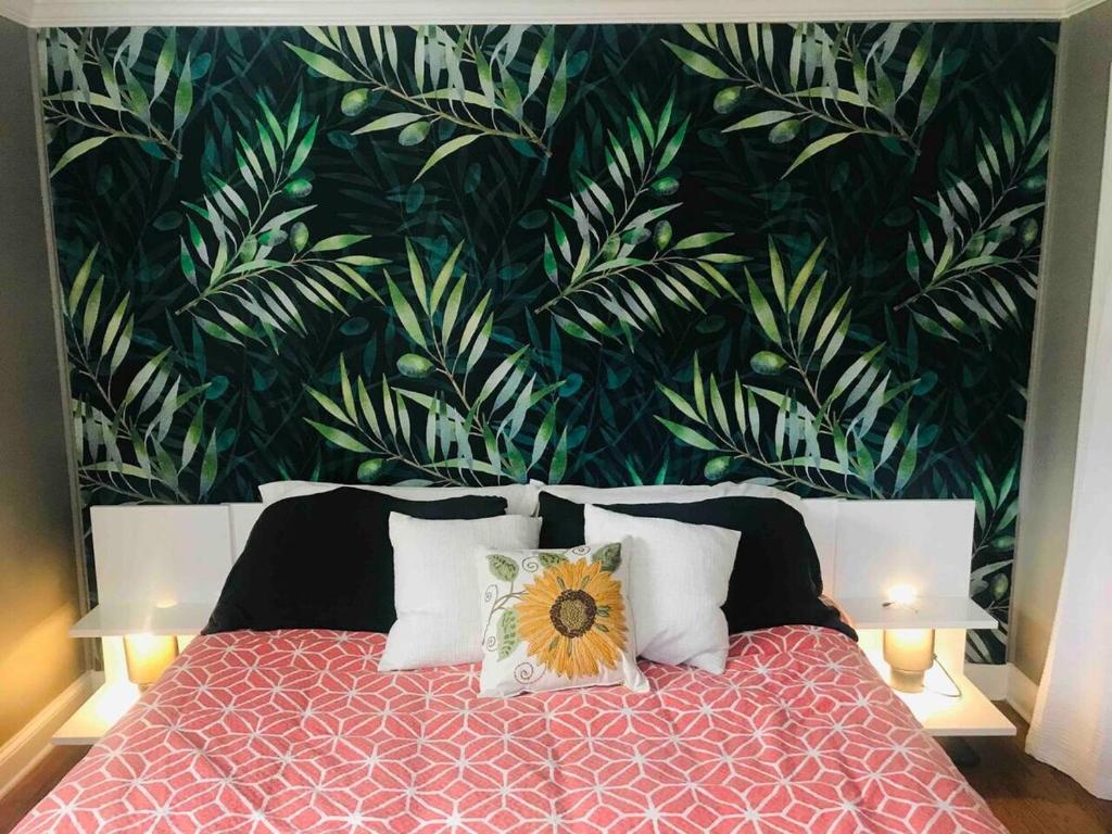 a bedroom with a bed with a floral wallpaper at Downtown - 2 bed, 1 bath - KC in Raleigh