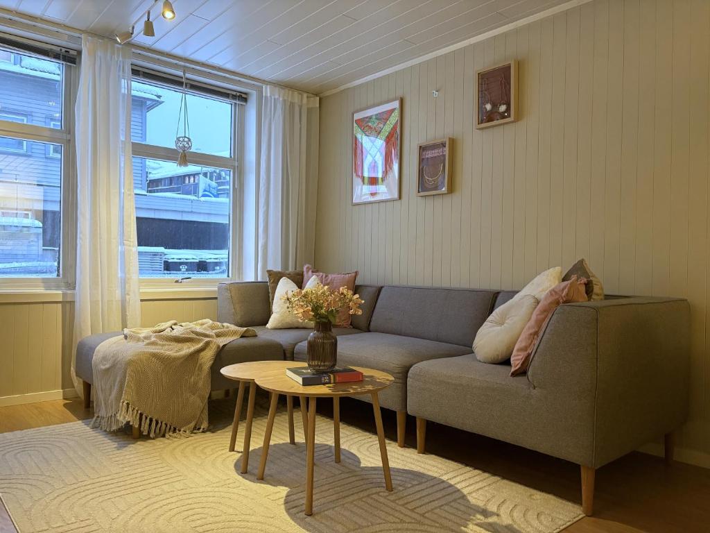 a living room with a couch and a table at Modern 2 bedroom apartment in the heart of Tromsø in Tromsø