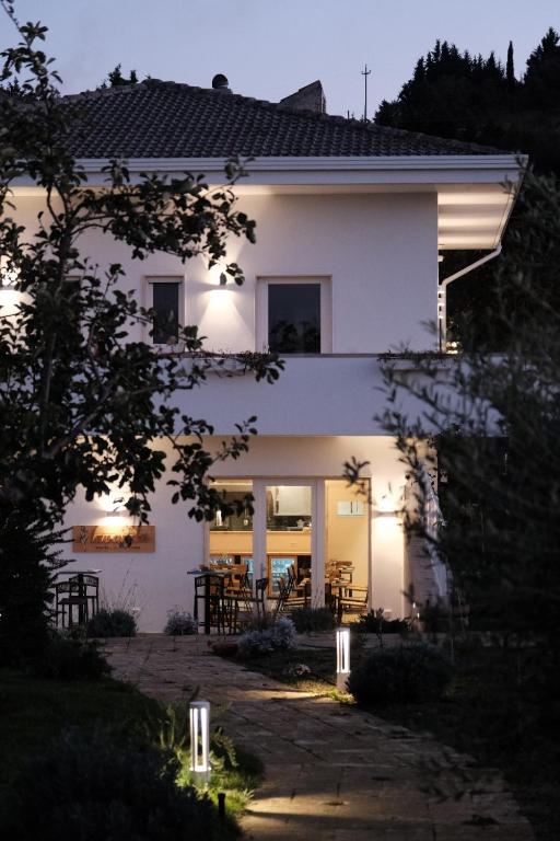 a white house with lights in front of it at L'Amarena Garden House in Matera