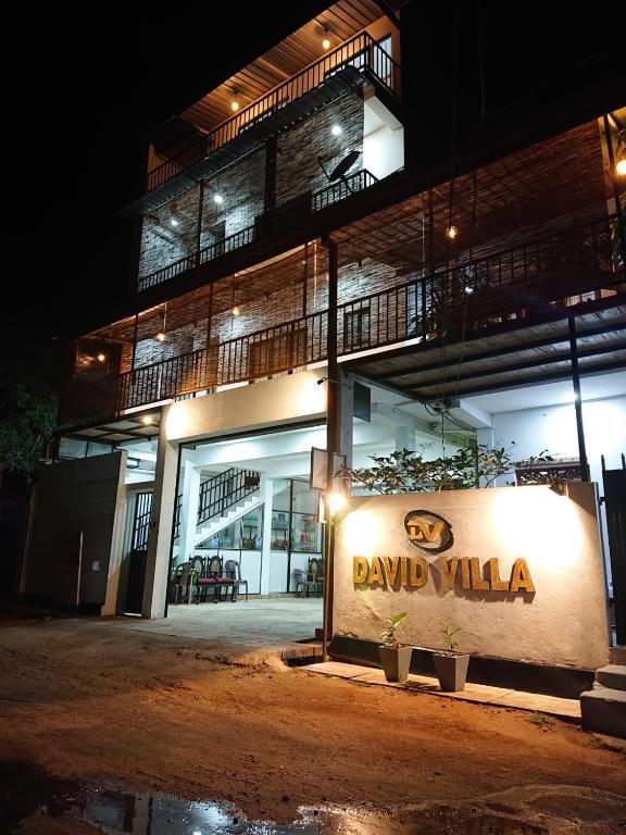 a building with a sign in front of it at night at David Villa in Anuradhapura