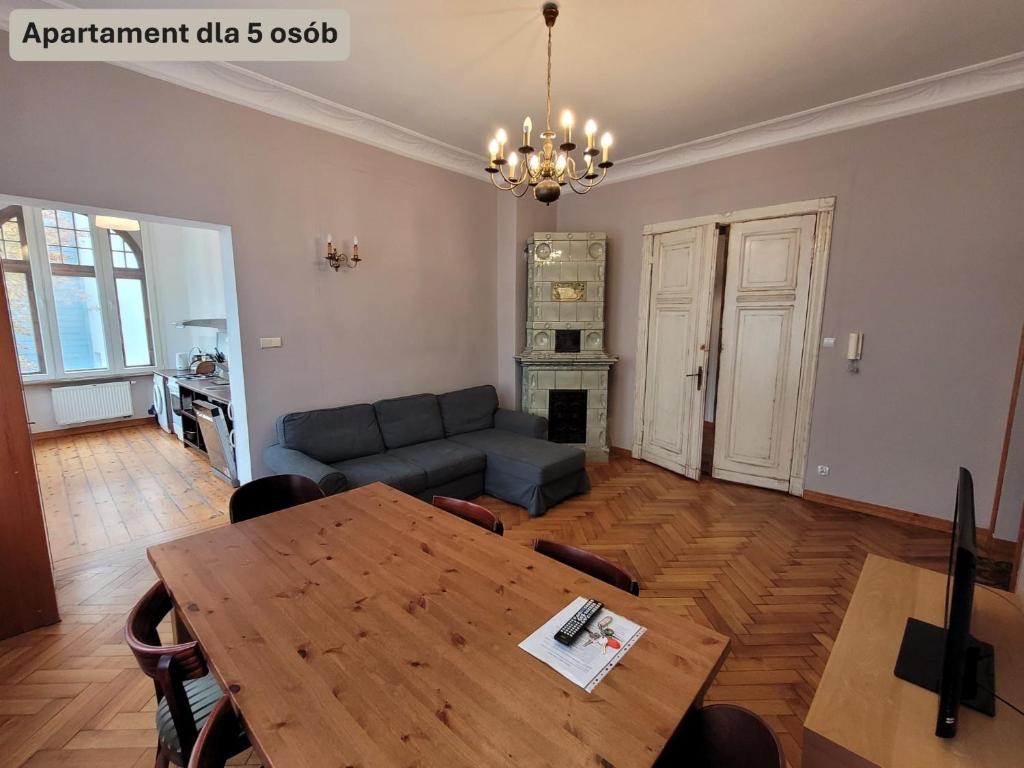 a living room with a table and a couch at Forum Sopot in Sopot